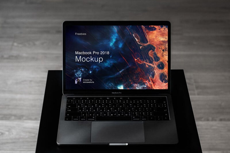 MacBook Pro on a dark Table Mockup